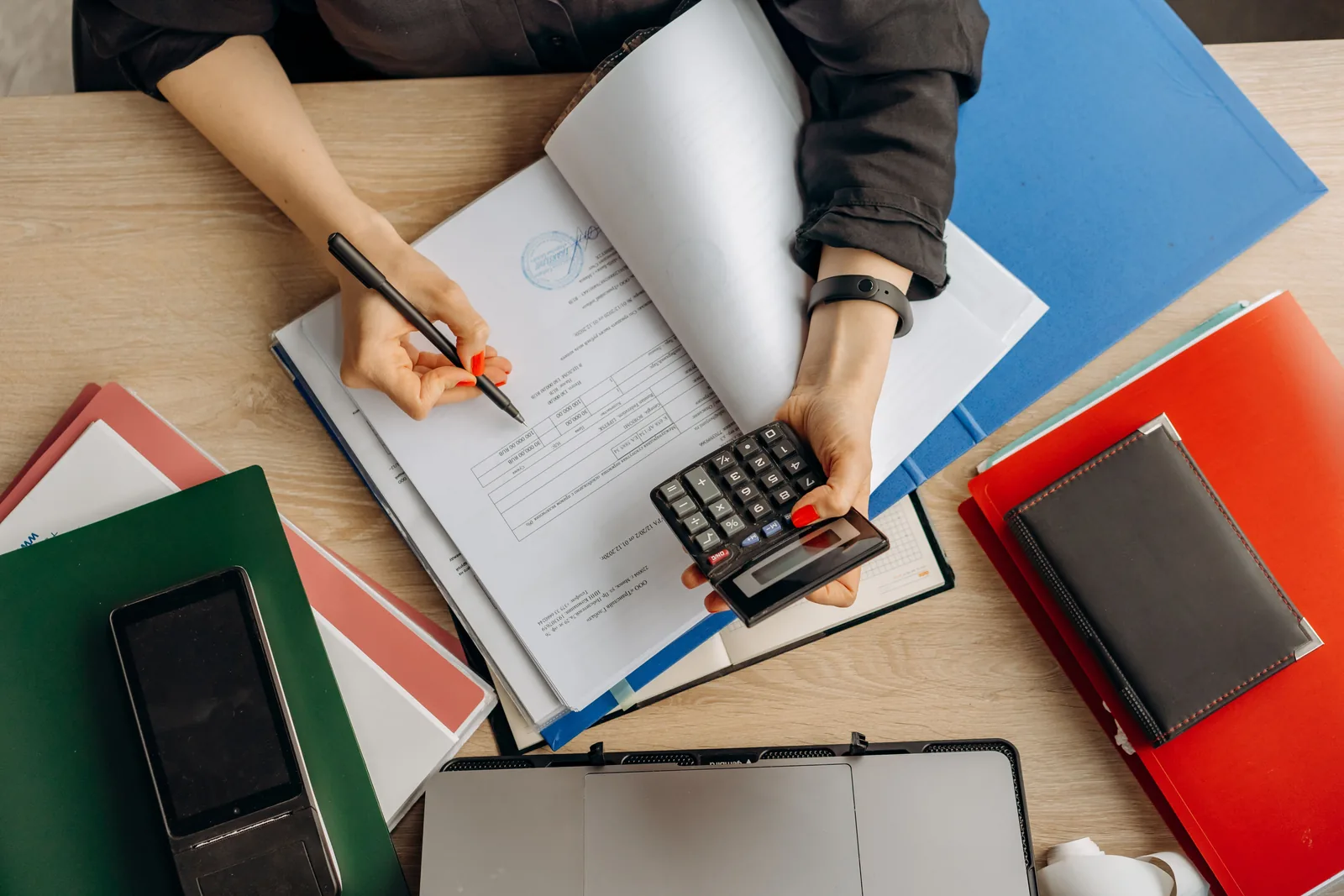 Reviewing financial paperwork with a calculator