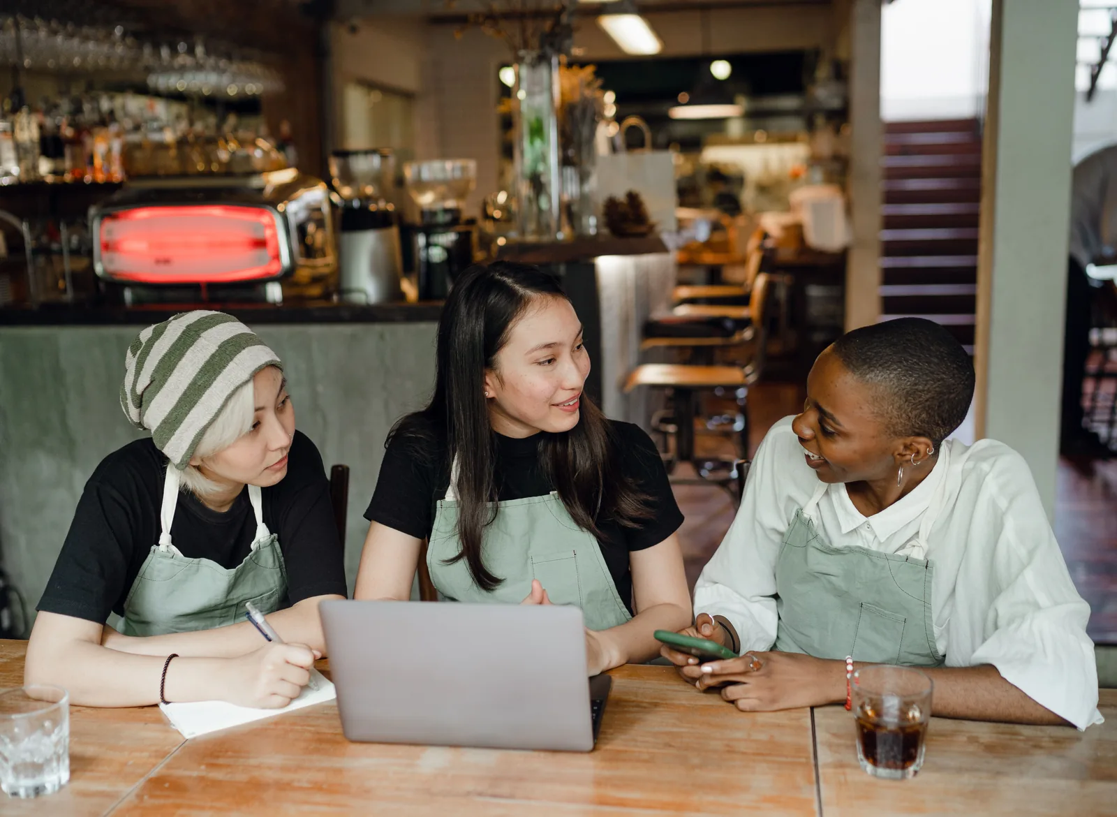 Restaurant team collaborating around a laptop